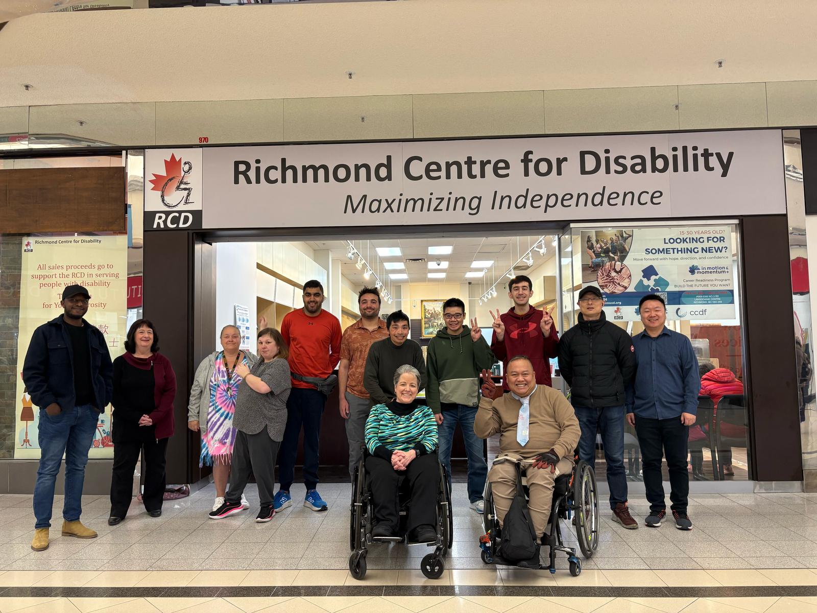 Group of people standing in front of the Richmond Center for Disability main office.