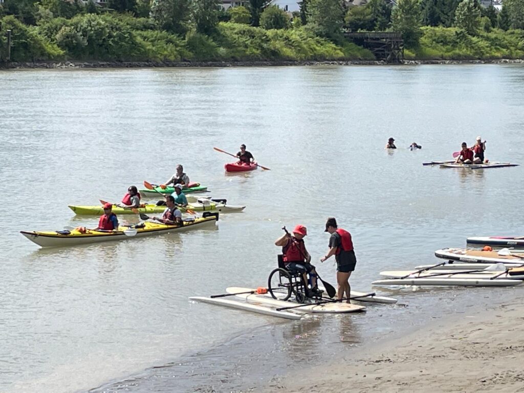 Multiple people kayaking in a river in Richmond.