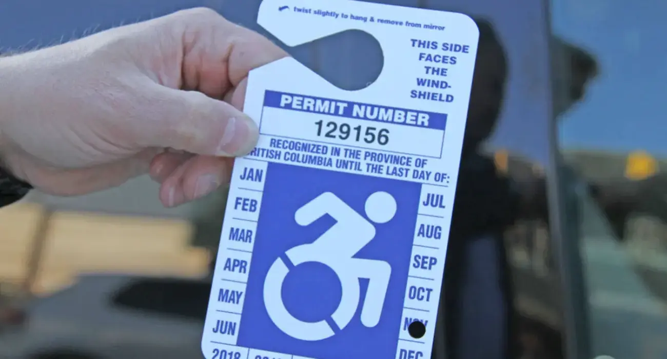 Somebody holding a parking permit.