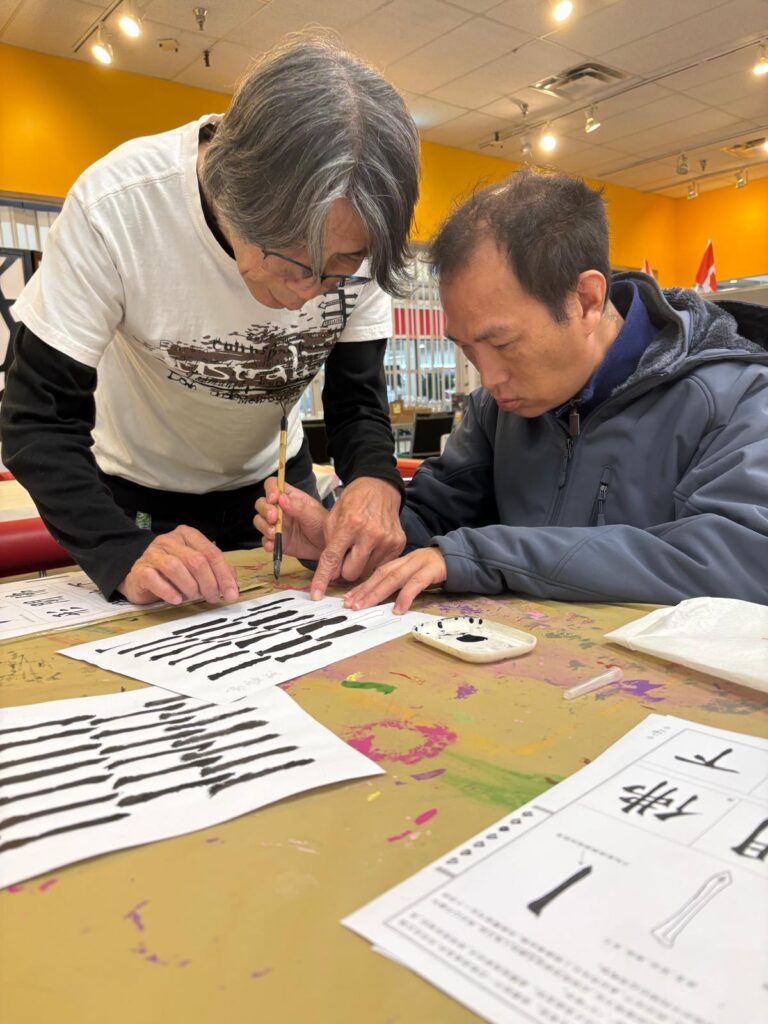 People learning how to write Chinese characters.