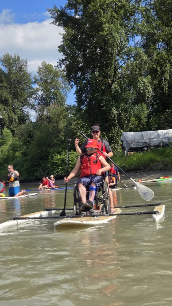 Person in a wheelchair on a paddleboard.